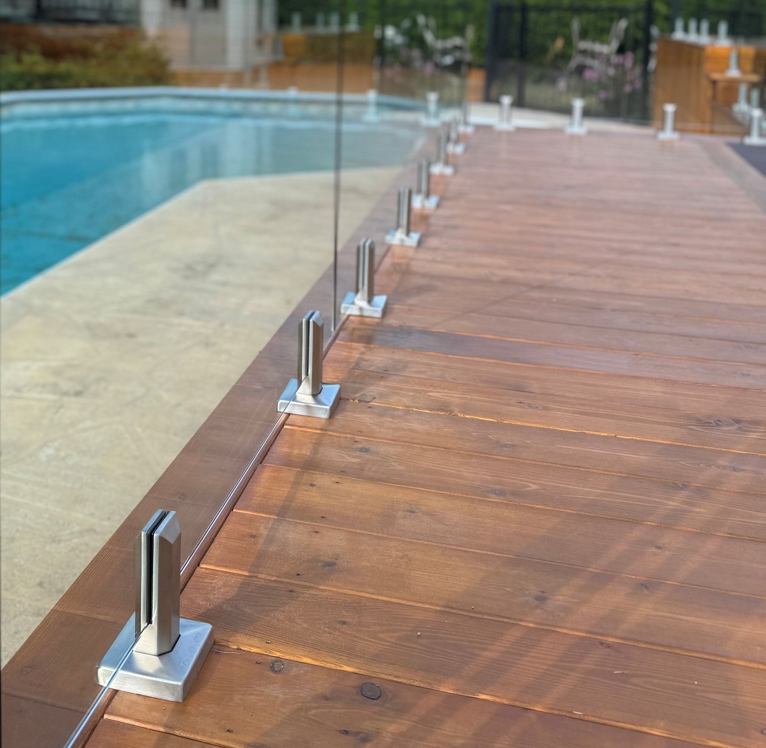 Clôture de piscine en verre trempé 12mm sur base de bois avec spigots carrés en acier inoxydable de couleur inox brossé Laval